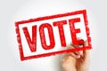 VOTE stamp with hand holding marker, rectangular civic imprint representing democratic participation, election process, voter Royalty Free Stock Photo