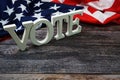 Vote Word alphabet letters with USA flag on wooden background