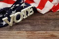 Vote Word alphabet letters with USA flag on wooden background