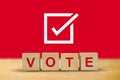 Vote on word letters cube, hand putting voting paper in the ballot box , illustration