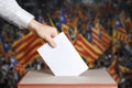 Voter Holds Envelope In Hand Above Vote Ballot. Catalonia Flags background. Democracy Concept Royalty Free Stock Photo