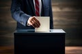 Voter putting voting paper in ballot box during elections. Election voting concept. Royalty Free Stock Photo