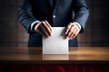 Voter putting voting paper in ballot box during elections. Election voting concept.