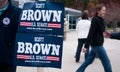 Voters pass a Scott Brown campaign volunteer in New Hampshire