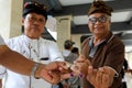 Voters show the dye marked on their fingers to indicate they have already voted, at a polling station in Ubud, Bali during regiona