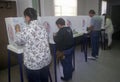 Voters and voting booths in a polling place