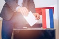 Voting box and election image, election. Hand of a person casting a vote into the ballot box during elections. Royalty Free Stock Photo