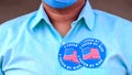 Voting Fraud Concept. Lack of trustworthiness for Mail-in voting. Man puts multiple I Voted By Mail stickers on the shirt