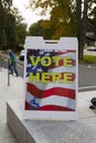 VOTING HERE Sign and Voters