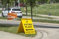 A Voting Place Elections Alberta sign on a busy street. Yellow double sided floor stand