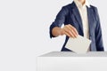 Voting. Woman putting a ballot into a voting box Royalty Free Stock Photo