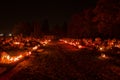 Votive candles lantern burning on the graves in Slovak cemetery at night time. All Saints' Day. Solemnity of All Saints Royalty Free Stock Photo