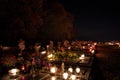 Votive candles lantern burning on the graves in Slovak cemetery at night time. All Saints' Day. Solemnity of All Saints Royalty Free Stock Photo