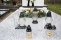 Votive candles lantern on the grave in Slovak cemetery. All Saints' Day. Solemnity of All Saints. All Hallows eve