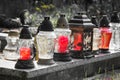 Votive candles lantern on the grave in Slovak cemetery. All Saints' Day. Solemnity of All Saints. All Hallows eve