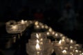 Votive prayer candles inside a catholic church on a candle rack Royalty Free Stock Photo