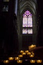 Votive and prayer candles with yellow light illuminating the darkness of Cologne Cathedral (Germany) Royalty Free Stock Photo