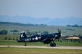 Vought F4U Corsair taxiing at Springbank Airport. WWII naval aircraft on mountains in background