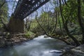 Vouraikos river is flowing under the bridge where the `Odontotos` rack railway train passes