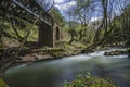 Vouraikos river is flowing under the bridge where the `Odontotos` rack railway train passes