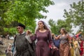 View of actors dressed in medieval clothes on medieval market, blurred background