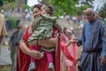 View of actors dressed in medieval clothes on medieval market, blurred background