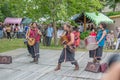 View of an outdoor celtic music concert, with musicians dressed in medieval costumes and playing medieval instruments, in medieval