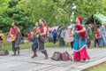 View of an outdoor celtic music concert, with musicians dressed in medieval costumes and playing medieval instruments, in medieval