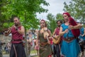 View of an outdoor celtic music concert, with musicians dressed in medieval costumes and playing medieval instruments, in medieval