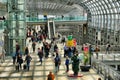 Voyagers silhouette at busy Porta Susa train station hall Turin Italy