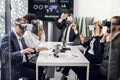 VR, business meeting conference. Multiethnical male and female business people wearing virtual reality headsets Royalty Free Stock Photo