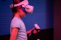 Vr game and virtual reality. kid girl gamer eight years old fun playing on futuristic simulation video game in 3d glasses and joys