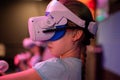 Vr game and virtual reality. kid girl gamer eight years old fun playing on futuristic simulation video game in 3d glasses and joys