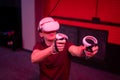 Vr game and virtual reality. man gamer fun playing on futuristic simulation video shooting game in 3d glasses and joysticks gun in Royalty Free Stock Photo