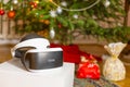 VR headset gift under the christmas tree with defocused lights Royalty Free Stock Photo