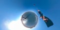 VR 360: Man does a selfie as female kiteboarder jumps past him on a sunny day.