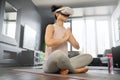 VR, meditation and fitness with a woman using a headset to access the metaverse in her home for health. Virtual reality
