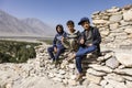 Vrang, Tajikistan August 24 2018: Three boys are sitting in Vrang on a Buddhist temple in the Wakhan valley in Tajikistan