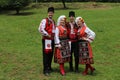 People in traditional authentic folklore costume a meadow near Vratsa, Bulgaria