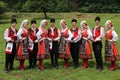 People in traditional authentic folklore costume a meadow near Vratsa, Bulgaria