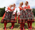 People in traditional authentic folklore costume a meadow