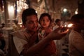 Vrindavan, 22 October 2016: A man with a child offering fire at Royalty Free Stock Photo