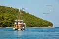 VRSAR, CROATIA - August 11th, 2019: Small cruise ship takes tourists for a short trip in Adriatic sea