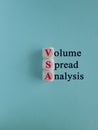 VSA symbol. Wooden cubes with red words VSA. Beautiful blue background. Business and Volume Spread Analysis concept.