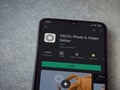 VSCO - Photo and Video Editor app play store page on a smartphone on ceramic stone background