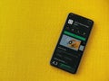 VSCO - Photo and Video Editor app play store page on smartphone on a yellow fabric background