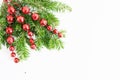 VTop view flat lay natural Christmas tree branches with red toys, bow and glass reindeer corner frame on bright background. New ye Royalty Free Stock Photo