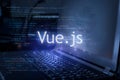 Vue.js inscription against laptop and code background. Learn vue programming language  computer courses  training Royalty Free Stock Photo