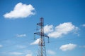 High voltage tower on blus cloudy sky background