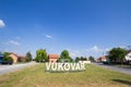 Vukovar sign at a road and street at the entrance of the city during a summer afternoon.